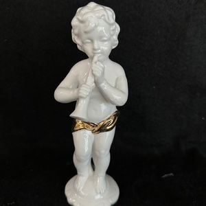 Vintage Porcelain Cherub playing horn.